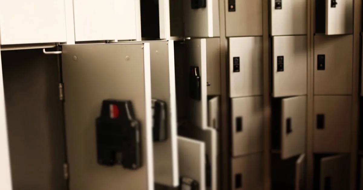 Rows of metal storage lockers with several doors left open.